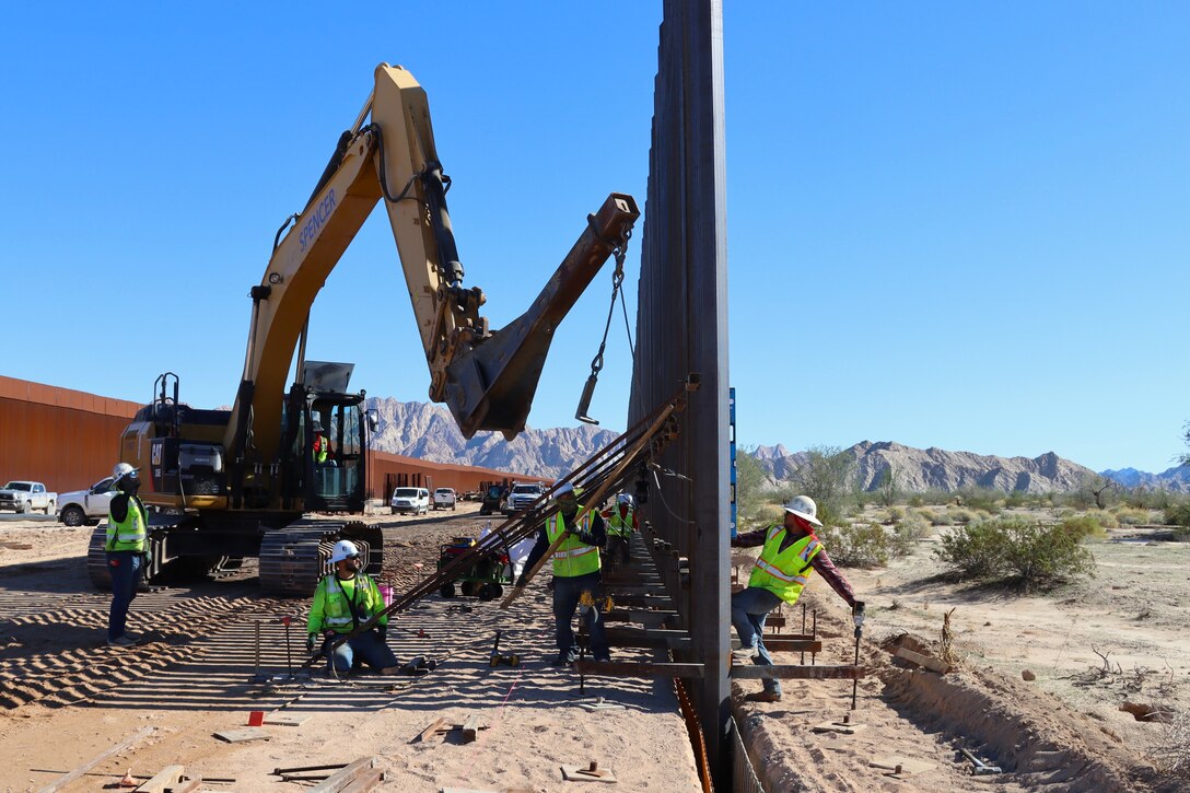 The U.S. Army Corps of Engineers contractors install border panels at the east end of the BMGR-1 project site near Yuma, Arizona, Dec. 16. USACE is replacing permanent border barriers along the southern border of the U.S. at the direction of the U.S. Army by the Secretary of War, in response to the presidential national emergency declaration dated Jan. 20, 2025, authorizing the use of Section 2803 of Title 10, U.S. Code. (no one in this image crossed the international border)