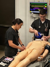 Navy Lt. Jenny Oliver, left, participates in simulated emergency medicine training at the Healthcare Simulation and Bioskills Center at Naval Medical Center Camp Lejeune on Dec. 10, 2025. Oliver graduated as an emergency medicine physician on Dec. 19 from the inaugural year for the Emergency Medicine Physician Assistant Fellowship at Navy Medicine Readiness and Training Command Camp Lejeune.
