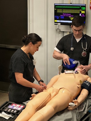Navy Lt. Jenny Oliver, left, participates in simulated emergency medicine training at the Healthcare Simulation and Bioskills Center at Naval Medical Center Camp Lejeune on Dec. 10, 2025. Oliver graduated as an emergency medicine physician on Dec. 19 from the inaugural year for the Emergency Medicine Physician Assistant Fellowship at Navy Medicine Readiness and Training Command Camp Lejeune.