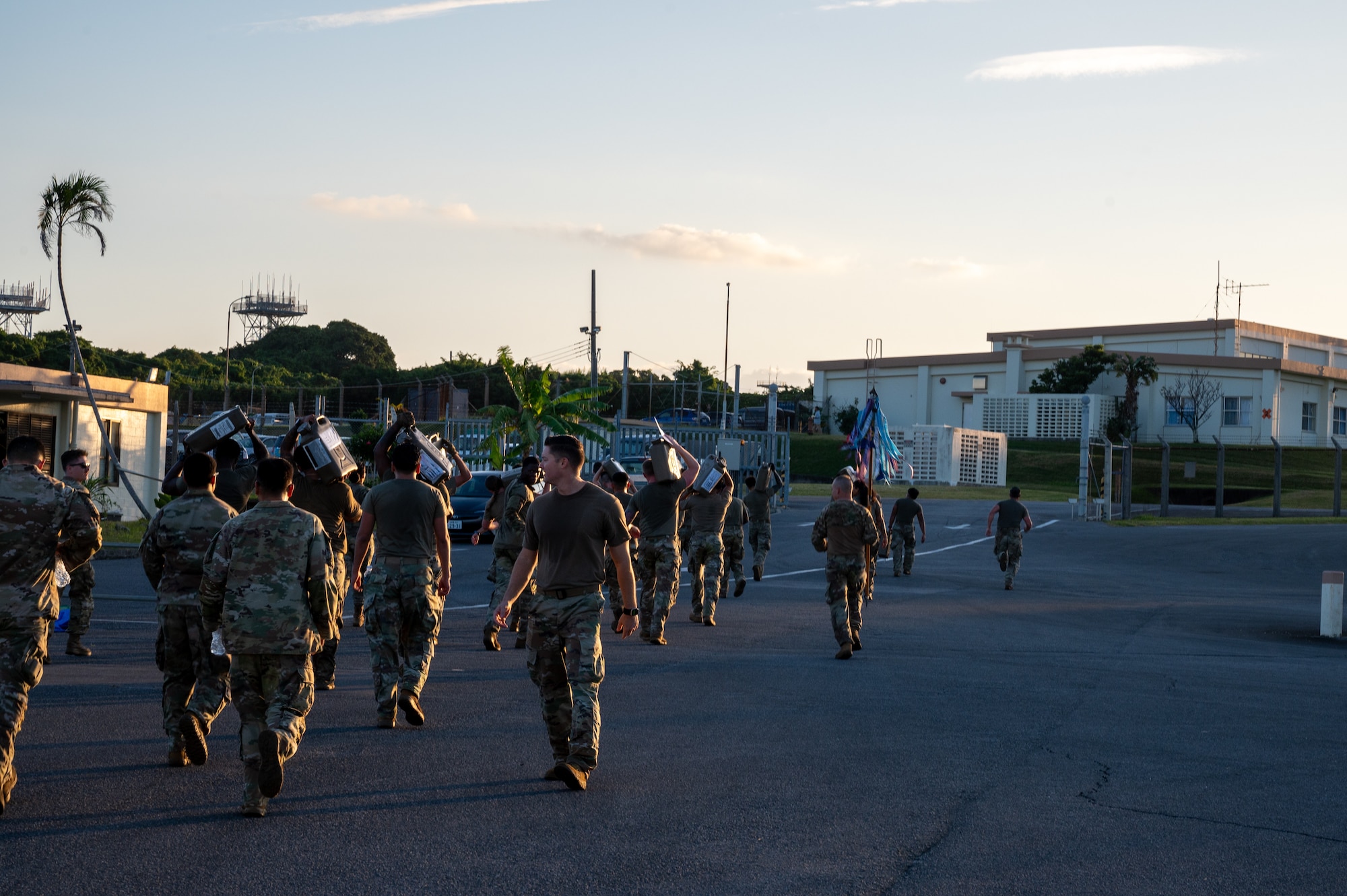 18th LRS Airmen carrying fuel canisters