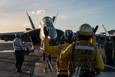 PHILIPPINE SEA (Dec. 19, 2025) — U.S. Navy Sailors direct an F/A-18F Super Hornet, attached to Strike Fighter Squadron (VFA) 41, on the flight deck of Nimitz-class aircraft carrier USS Abraham Lincoln (CVN 72) on Dec. 19, 2025. The Abraham Lincoln...