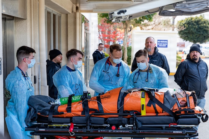 YOKOSUKA, Japan (Dec. 18, 2025) – U.S. Navy medical personnel assigned to U.S. Naval Hospital Yokosuka treat a simulated injured person at the hospital Emergency Room during the Joint Response Drill, Dec. 18, 2025. The drill, led by Commander, Submarine Group 7, simulates a medical emergency aboard the nuclear-powered aircraft carrier USS George Washington (CVN 73). Now in its 18th iteration, this U.S.-Japan Joint Response Drill demonstrates the integral coordination and cooperation between the U.S. Navy, Government of Japan, and City of Yokosuka that further supports the alliance between the two nations. (U.S. Navy photo by Mass Communication Specialist 2nd Class Daniel G. Providakes)
