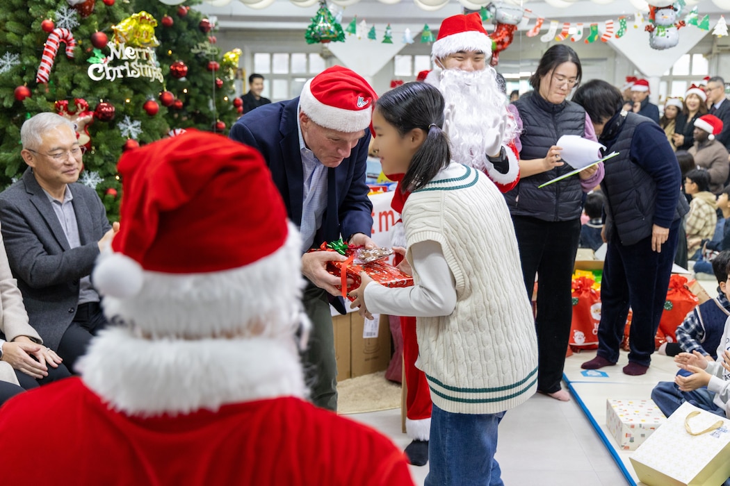 Lt. Gen. Joseph Hilbert, Eighth Army commanding general, hands a young girl a Christmas present at Namsan-won Orphanage in Seoul, South Korea, Dec. 19, 2025.