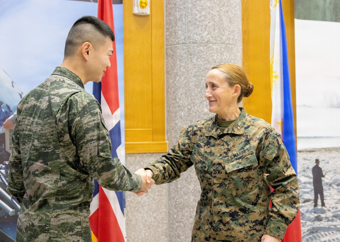 U.S. Marine Corps Maj. Gen. Valerie A. Jackson, commander of U.S. Marine Corps Forces, Korea, shakes hands with Republic of Korea Marine Corps Capt. Jeong Sang Jin, liaison officer to MARFORK from the ROKMC, during a farewell ceremony on USAG Camp Humphreys, South Korea, Dec. 23, 2025. From Jan. 13 to Dec. 23, 2025, Jeong worked as a critical link in the planning and execution of bilateral ROKMC and MARFORK events. To succeed, he was required to coordinate with staff, balance schedules, and transcend language barriers across warfighting functions and with key leaders in both commands.