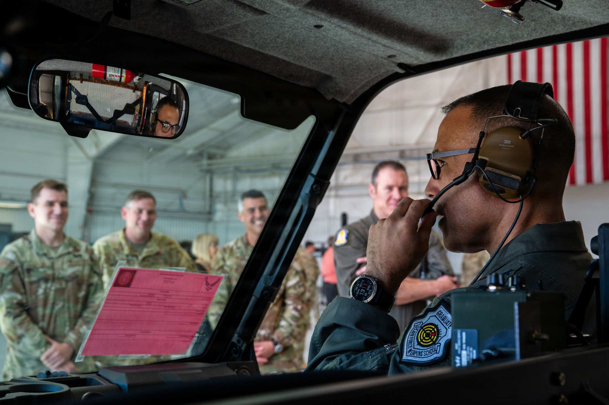 U.S. Air Force Gen. Adrian Spain, commander of Air Combat Command, uses newly implemented radio capabilities at Davis-Monthan Air Force Base, Arizona, Dec. 16, 2025. The ACC command team visited an innovation demonstration where squadrons from across the installation discussed their mission sets and ongoing innovation efforts with Air Combat Command leadership. (U.S. Air Force photo by Senior Airman Jasmyne Bridgers-Matos)