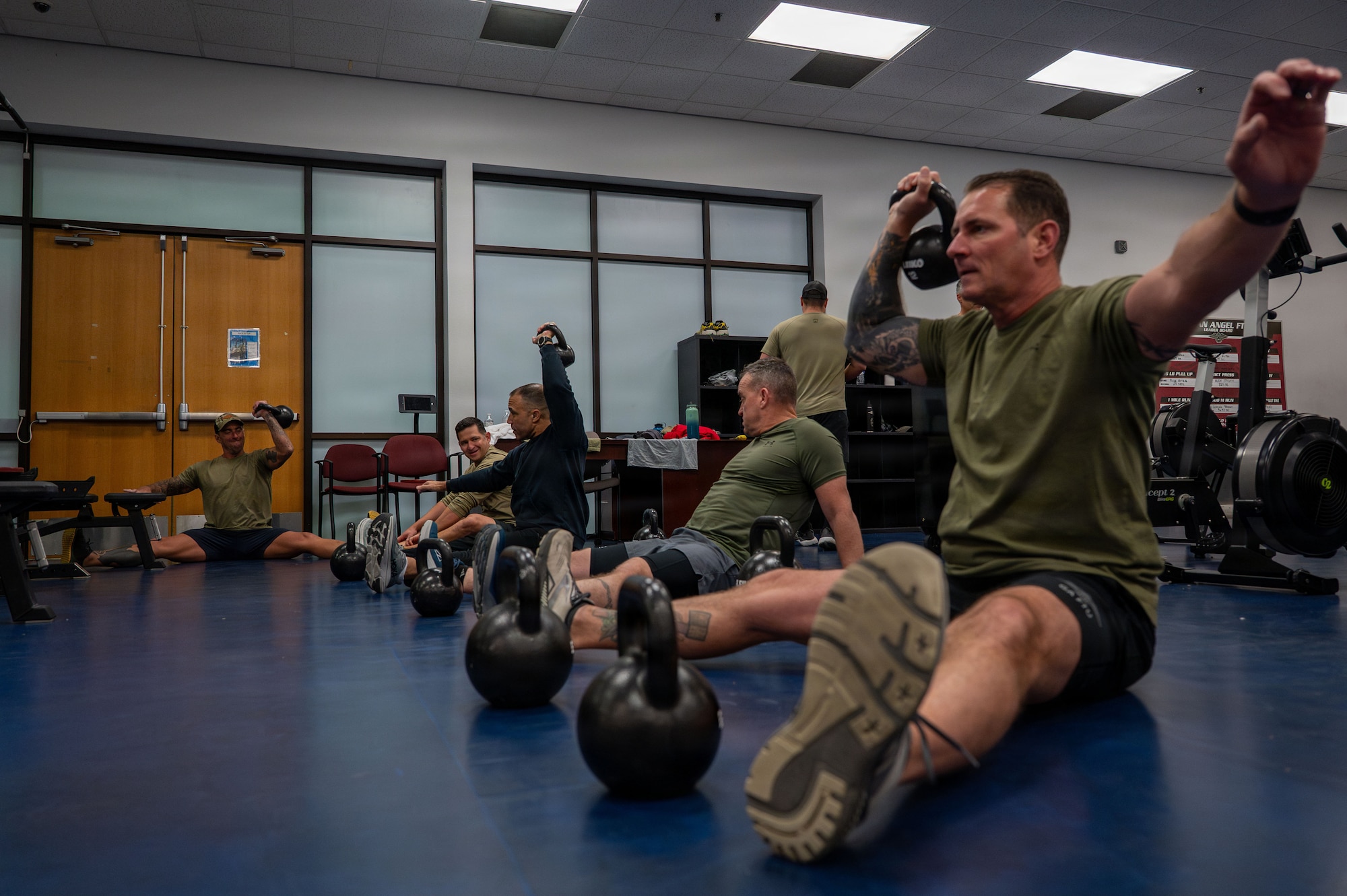 U.S. Air Force Gen. Adrian Spain, commander of Air Combat Command, and Chief Master Sergeant Jeremy Unterseher, ACC command chief, conduct physical training with the 68th Rescue Squadron at Davis-Monthan Air Force Base, Arizona, Dec. 16, 2025. Spain and Unterseher started their day with PT highlighting the importance of readiness and echoing the Secretary of War's call for a fit force. (U.S. Air Force photo by Senior Airman Jasmyne Bridgers-Matos)