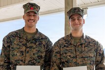 U.S. Marine Corps Cpl. Malikah Warren, 2nd Distribution Support Battalion, 2nd Marine Logistics Group, left, and Cpl. Zbigniew Adamczyk, Marine Medium Tiltrotor Training Squadron 204, Marine Aircraft Group 26, 2nd Marine Aircraft Wing, right, pose for a photo after receiving Red Cross Lifesaving Awards at Marine Corps Base Camp Lejeune, North Carolina, Dec. 16, 2025. The Marines received the Lifesaving Award, the second highest award the American Red Cross bestows, for rescuing people during an emergency at a local beach earlier this year. (U.S. Marine Corps photo by Lance Cpl. Erica S. Padgett)