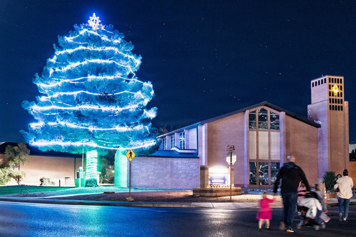 A family walks by the newly-lit base chapel tree at Holloman Air Force Base, New Mexico, Dec. 5, 2025.