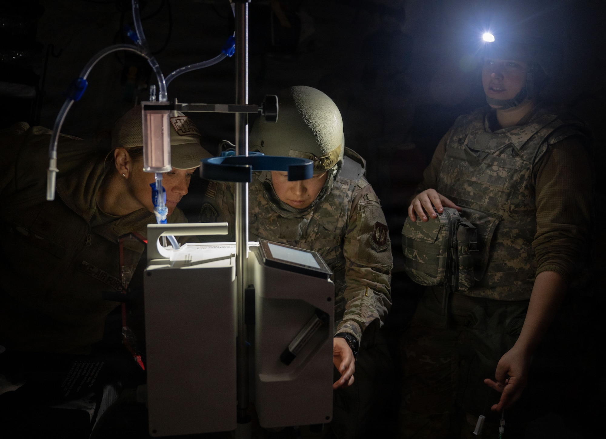 Medical personnel work in the dark.