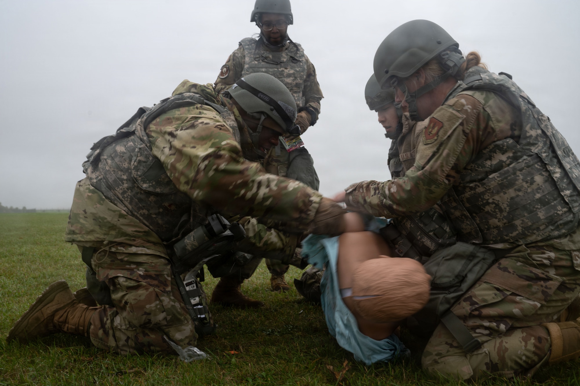 Military members roll a mannequin.