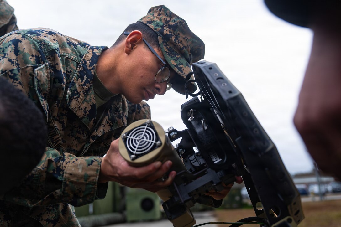 U.S. Marine Corps Lance Cpl. Angel Quijada, a satellite transmissions system operator with 2nd Distribution Support Battalion, Combat Logistics Regiment 2, 2nd Marine Logistics Group, sets up a Lite Sat 1.3m terminal during a Commercial Satellite Communication Operator Course at Marine Corps Base Camp Lejeune, Dec. 18, 2025. The purpose of CSCOC is to provide knowledge and hands on training with commercial off-the-shelf communication equipment to modernize communication efforts in accordance with Force Design. Quijada is a native of New Jersey. (U.S. Marine Corps photo by Lance Cpl. Brady V. Hathaway)