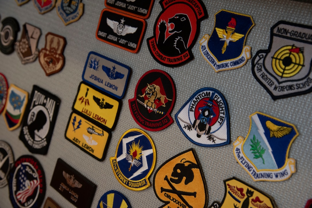 U.S. Air Force Capt. Joshua A. Lemon, 316th Operations Group executive officer, displays his collection of patches – many of which he acquired as an enlisted Airman – at his office at Joint Base Andrews, Maryland, Sept. 23, 2025. While enlisted, Lemon served as an airborne cryptologic language analyst translating Korean; Survival, Evasion, Resistance and Escape instructor; and squadron senior enlisted leader before commissioning.
