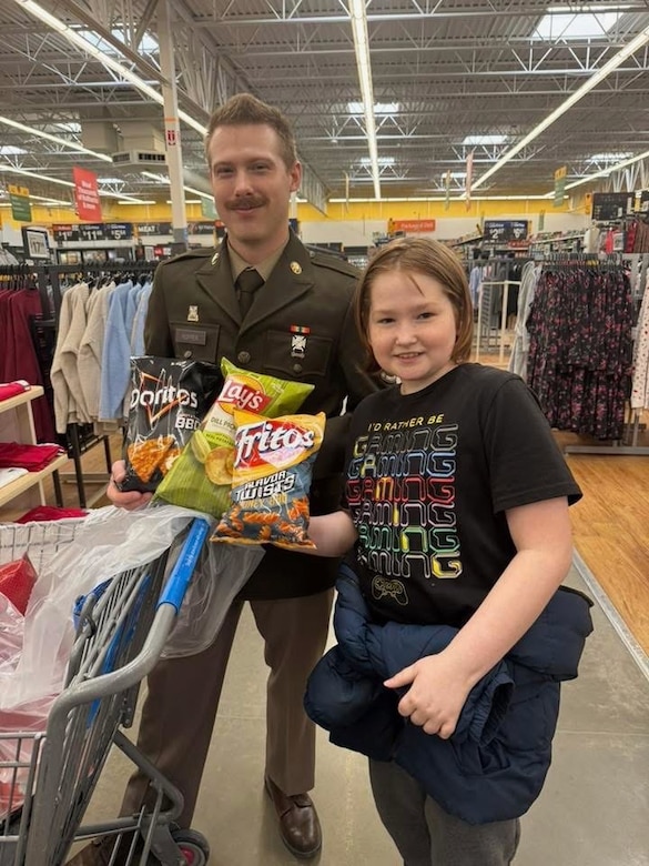 Soldier posing with a kid.