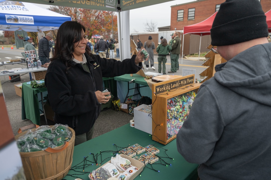 A vendor hands an item to an event attendee.