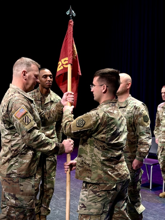 Capt. Josh Tanneberger, the new Commander of the 725th Transportation Company, passes the unit’s guidon to 1st Sgt. Eric Daggett symbolizing the trust he places in the unit’s Noncommissioned Officer Corps.