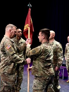 Capt. Josh Tanneberger, the new Commander of the 725th Transportation Company, passes the unit’s guidon to 1st Sgt. Eric Daggett symbolizing the trust he places in the unit’s Noncommissioned Officer Corps.