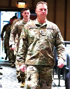 1st Sgt. Eric Daggett, the senior enlisted leader of the 725th Transportation Company, files in during the unit’s Welcome Home Ceremony.