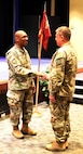 Illinois Army National Guard Staff Sgt. Kevin Leonard of the 725th Transportation Company shakes hands with Maj. Gen. Rodney Boyd, The Adjutant General of Illinois and Commander of the Illinois National Guard.