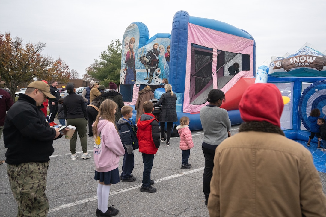 People gathered around a bouncy house