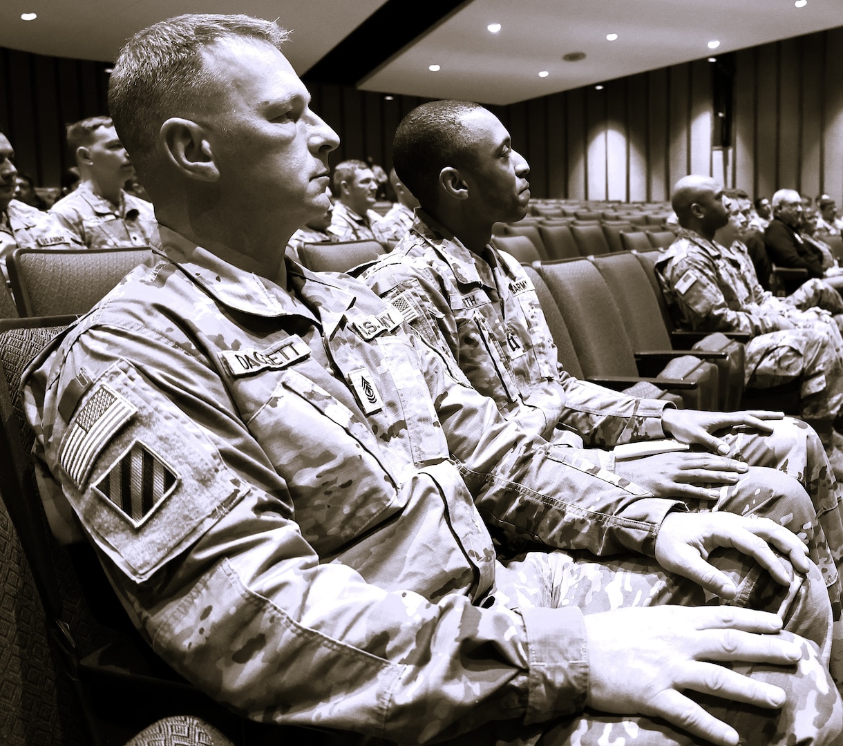 Capt. (promotable) Charles Smith, right, and 1st Sgt. Eric Daggett, left, listen to Maj. Gen. Rodney Boyd, The Adjutant General and Commander of the Illinois National Guard.
