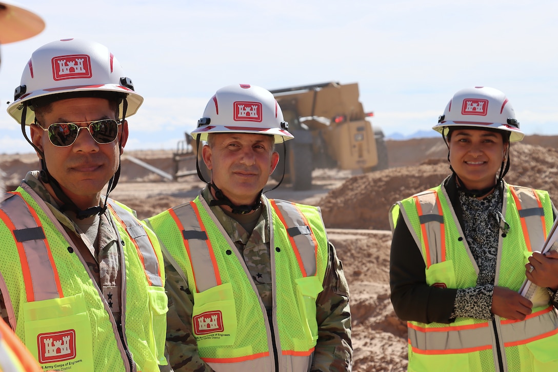 From left, U.S. Army Corps of Engineers’ Maj. Gen. Mark Quander, deputy commanding general for military and international operations, Brig. Gen. John Lloyd, commander of the South Pacific Division, and Angela Tugaoen, area engineer for the South Pacific Border Task Force during border barrier installation at the BMGR-1 project site Nov. 17 near Yuma, Arizona. USACE is replacing permanent border barriers along the southern border of the U.S. at the direction of the U.S. Army by the Secretary of War, in response to the presidential national emergency declaration dated Jan. 20, 2025, authorizing the use of Section 2803 of Title 10, U.S. Code.