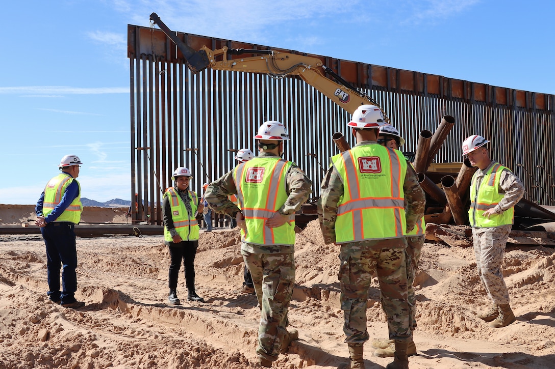 Senior Leaders from the U.S. Army Corps of Engineers monitor border barrier installation at the BMGR-1 project site Nov. 17 near Yuma, Arizona. USACE is replacing permanent border barriers along the southern border of the U.S. at the direction of the U.S. Army by the Secretary of War, in response to the presidential national emergency declaration dated Jan. 20, 2025, authorizing the use of Section 2803 of Title 10, U.S. Code