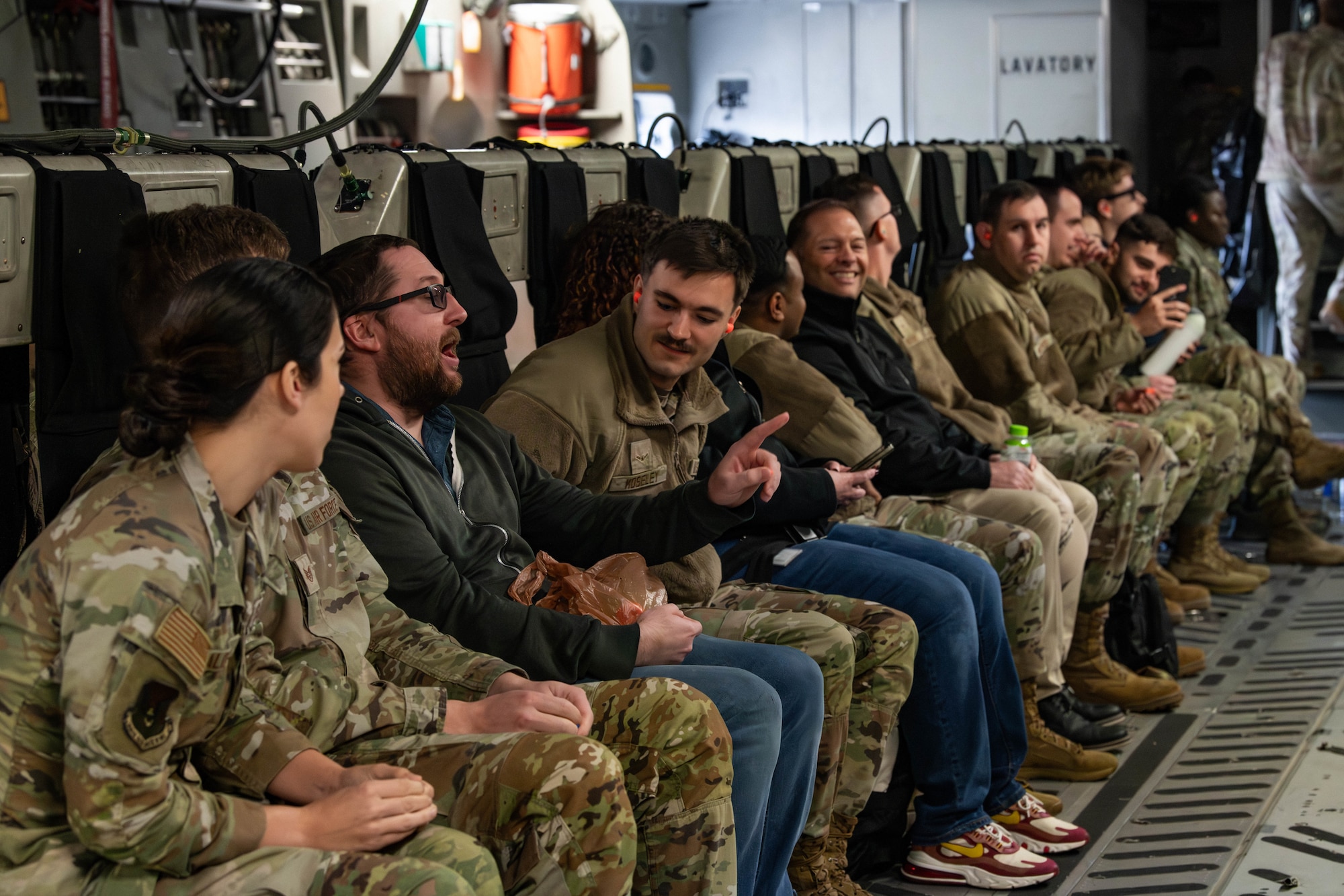 A photo of people conversing in a C-17 Globemaster III