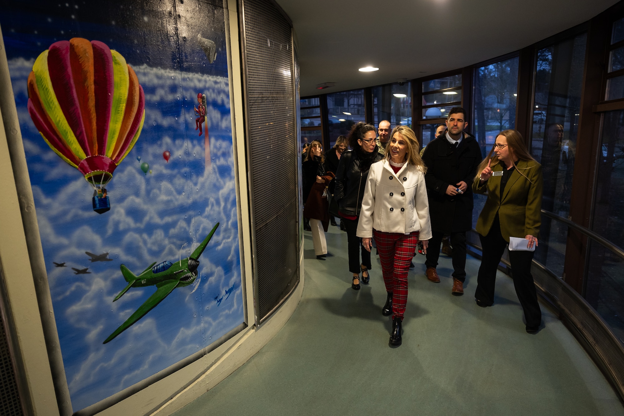 Mrs. Cindy Wilsbach, wife of Air Force Chief of Staff Gen. Ken Wilsbach, middle, receives a tour of the School Age Center at Ramstein Air Base, Germany, Dec. 23, 2025. The engagement illustrates how relationships built through communication and care for families enhances Airmen readiness, the wing’s resilience and overall mission effectiveness. (U.S. Air Force photo by Senior Airman Edgar Grimaldo)