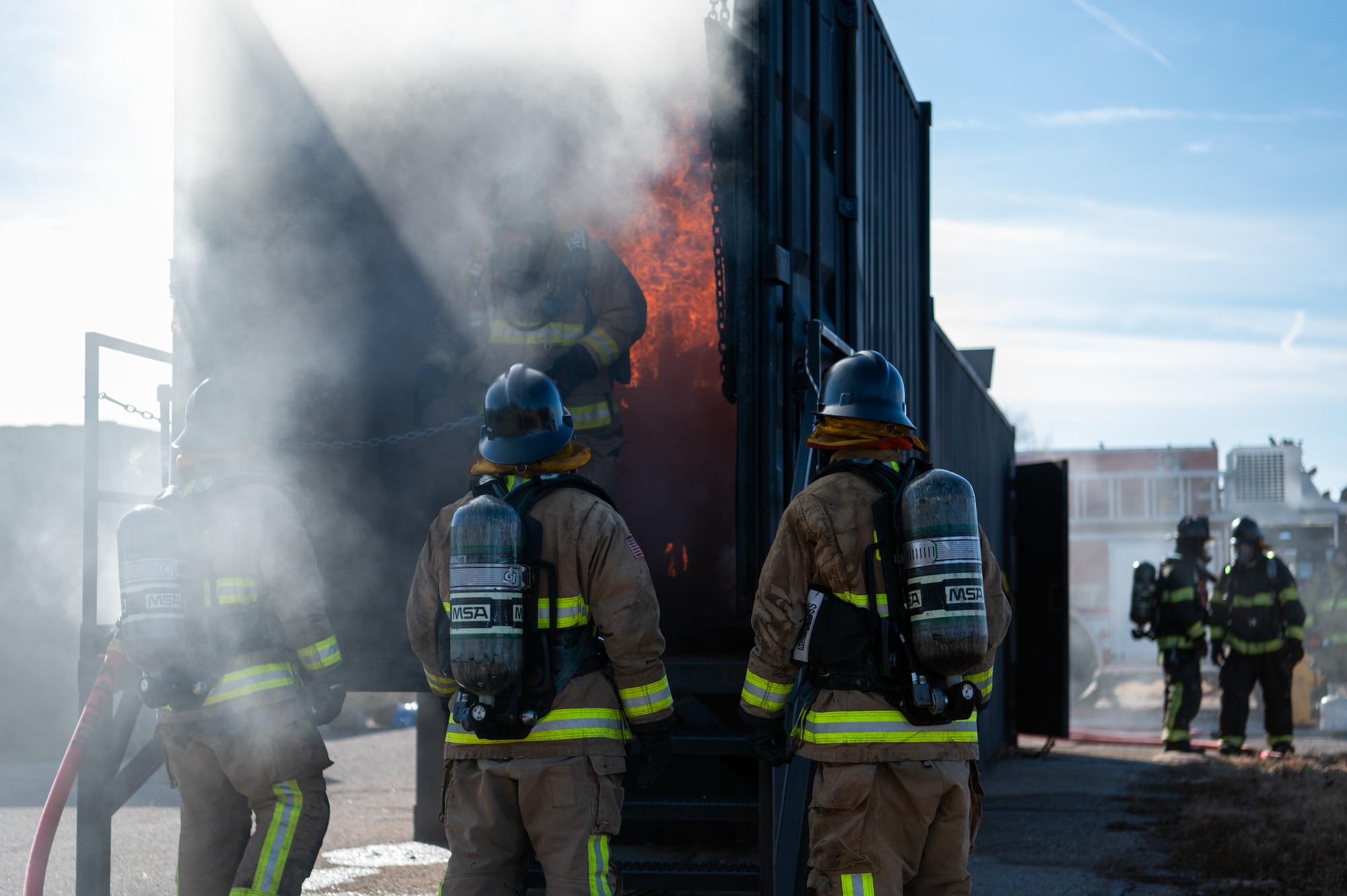 firefighters participate in live fire training