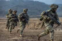 Soldiers assigned to Charlie Company, 2-23 Infantry Regiment, 1st Stryker Brigade Combat Team, conduct a Combined Arms Live-Fire Exercise, honing their combat skills through realistic training scenarios.