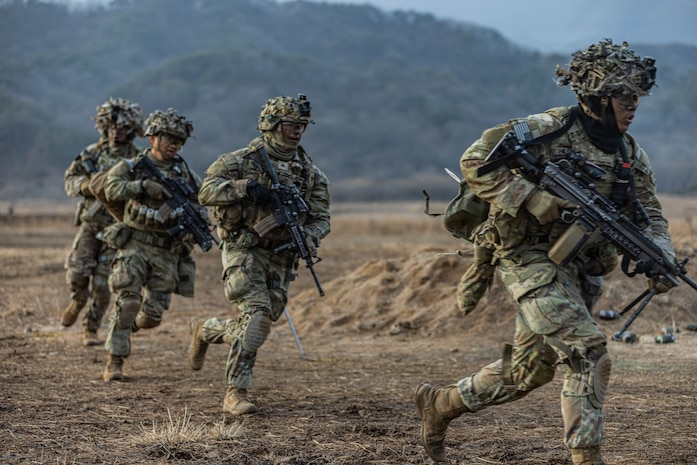 Soldiers assigned to Charlie Company, 2-23 Infantry Regiment, 1st Stryker Brigade Combat Team, conduct a Combined Arms Live-Fire Exercise, honing their combat skills through realistic training scenarios.