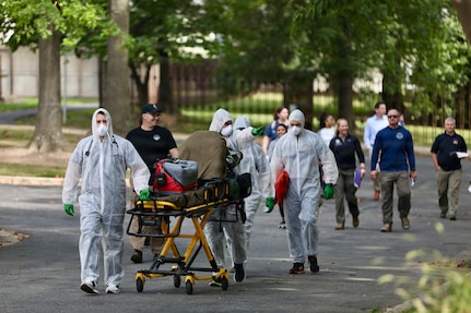 Members of the D.C. National Guard's 33rd Weapons of Mass Destruction Civil Support Team (WMD-CST) join MedStar Health SiTEL clinicians, physicians, and medical students for an advanced emergency simulation in Northwest Washington, D.C., Aug. 28, 2025. The joint exercise tested rapid medical response in contaminated and high-risk environments, strengthening interagency readiness and ensuring both partners are better prepared to protect the community.