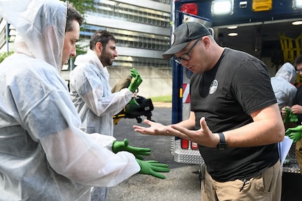 Members of the D.C. National Guard's 33rd Weapons of Mass Destruction Civil Support Team (WMD-CST) join MedStar Health SiTEL clinicians, physicians, and medical students for an advanced emergency simulation in Northwest Washington, D.C., Aug. 28, 2025. The joint exercise tested rapid medical response in contaminated and high-risk environments, strengthening interagency readiness and ensuring both partners are better prepared to protect the community.