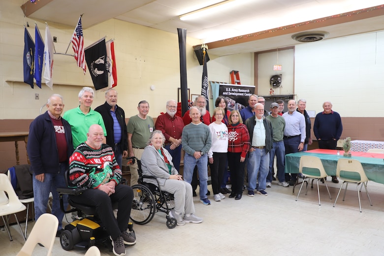 Julie Marcy (second from left, front row) and Ernie Smith (second from left, second row) pose with fellow ERDC Alumni Association members after presenting "comfort critters" to Vicksburg law enforcement, Emergency Management and Fire Department officials.
