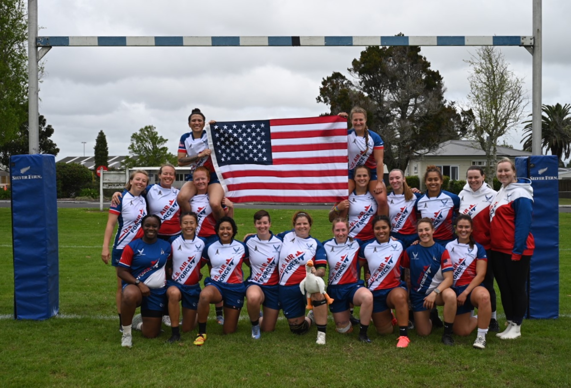 U.S. Space Force Maj. Adekunbi Adewunmi, bottom row left, poses with the Department of the Air Force (DAF) women’s rugby team during the Royal Australian Air Force, Royal New Zealand Air Force, and U.S. Department of the Air Force (ANZUS) Shield tournament at Whenuapai Air Base, New Zealand, Oct. 9-11. Adewunmi, stationed at Vandenberg Space Force Base, Calif., made history by coaching the DAF team to their first-ever championship victory at the tournament.  (U.S. Air Force photo by 1st Lt. Kate Anderson)