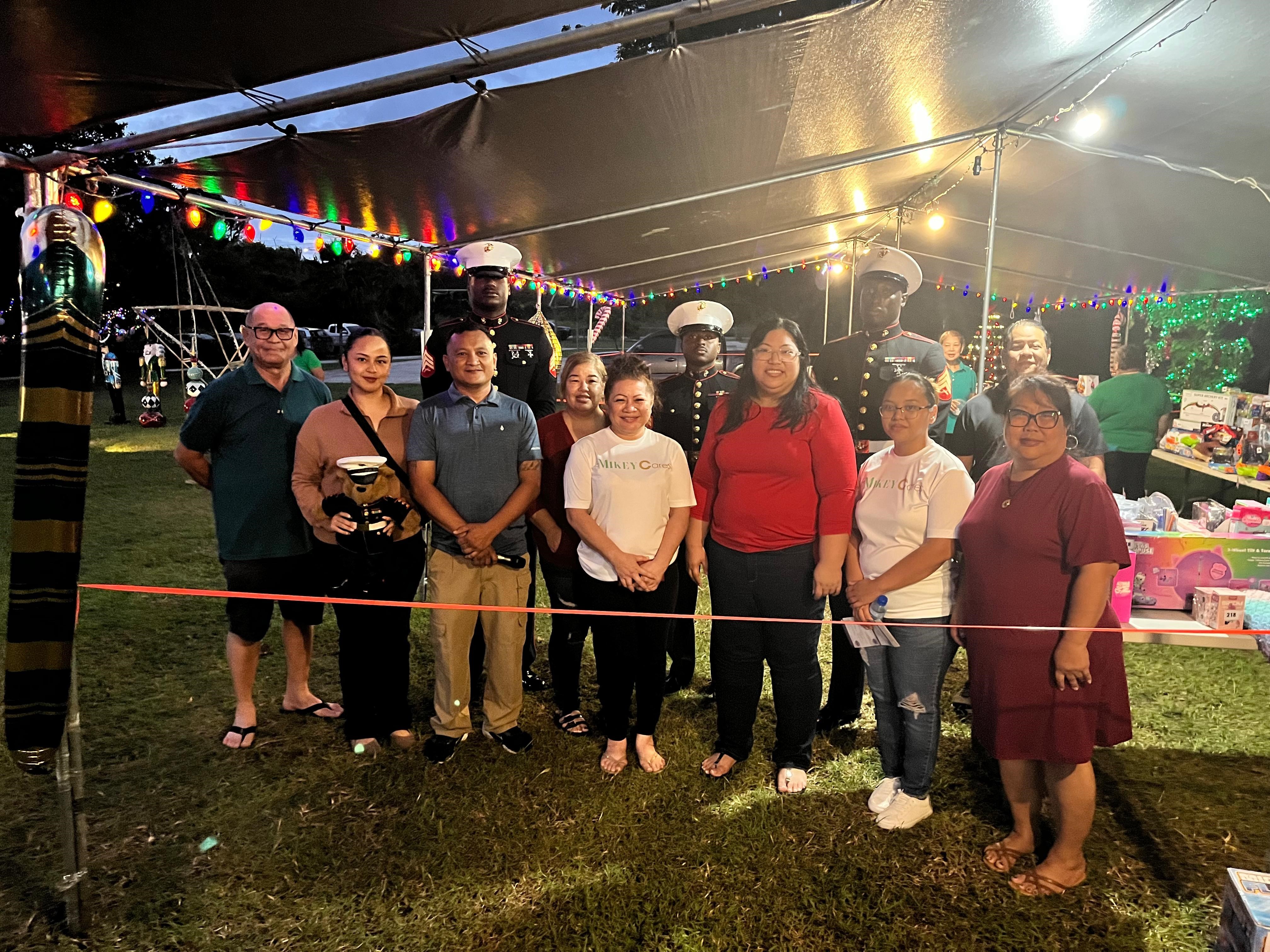 U.S. Marines with Marine Corps Base Camp Blaz, and volunteers, pose for a photo during the distribution of toys for the Toys for Tots Campaign, Rota, Dec. 21, 2025. This year marks the 78th year of the national Marine Corps Toys for Tots Campaign and the 9th year in the Commonwealth of the Northern Mariana Islands. The mission of the Toys for Tots Program is to collect new, unwrapped toys and distribute those toys to children at Christmas. (U.S. Marine Corps courtesy photo by Uriah Perez)