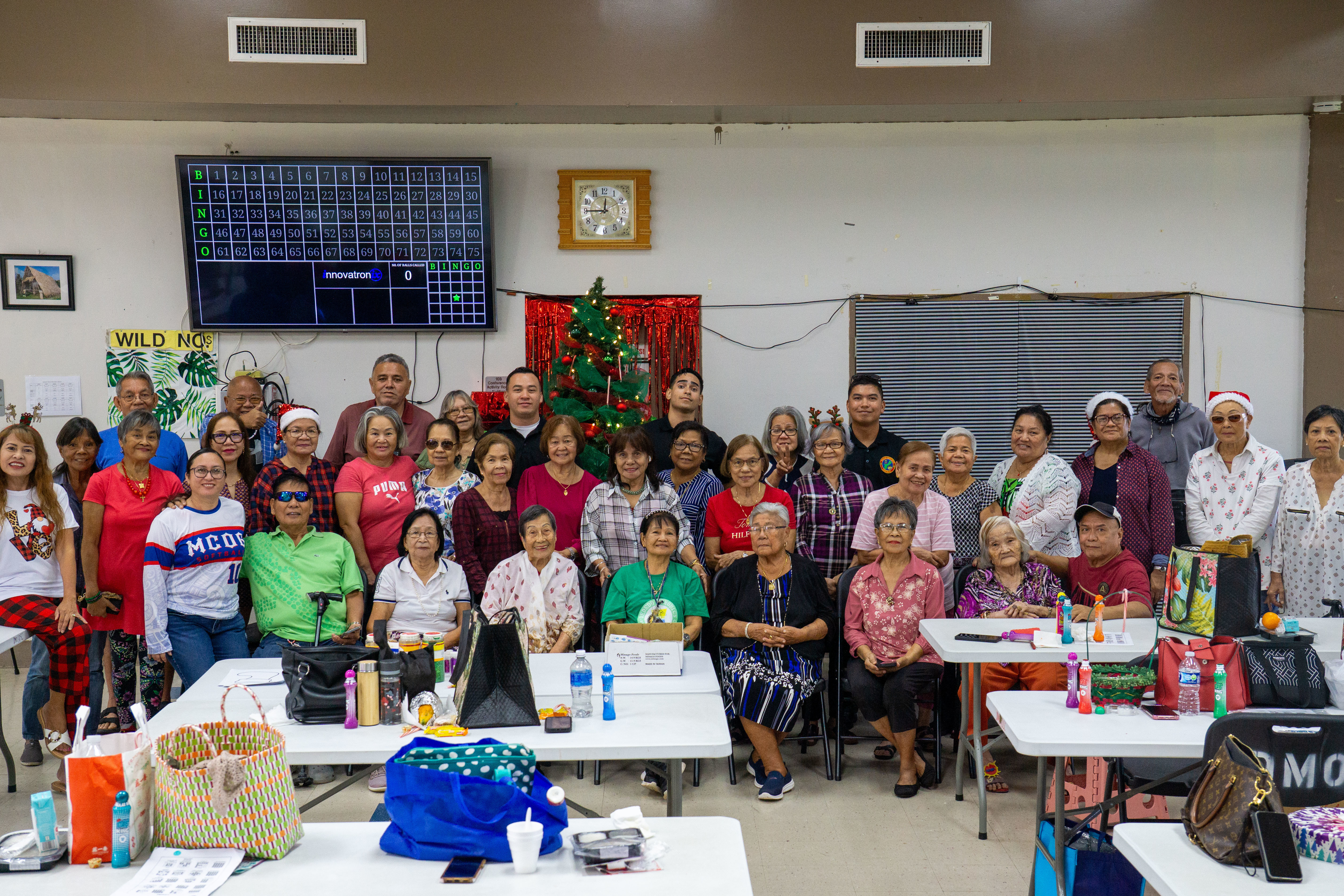 U.S. Marines with Marine Corps Base Camp Blaz, and residents of the village of Dededo, pose for a group photo at the conclusion of a COMREL (Community Relations) event at the Dededo Senior Center, Dededo, Guam, Dec. 19, 2025. Marines and civilian counterparts are encouraged to participate in COMRELs to increase community engagement and identify opportunities for service. (U.S. Marine Corps photo by Chelsey Suarez-Pierce)
