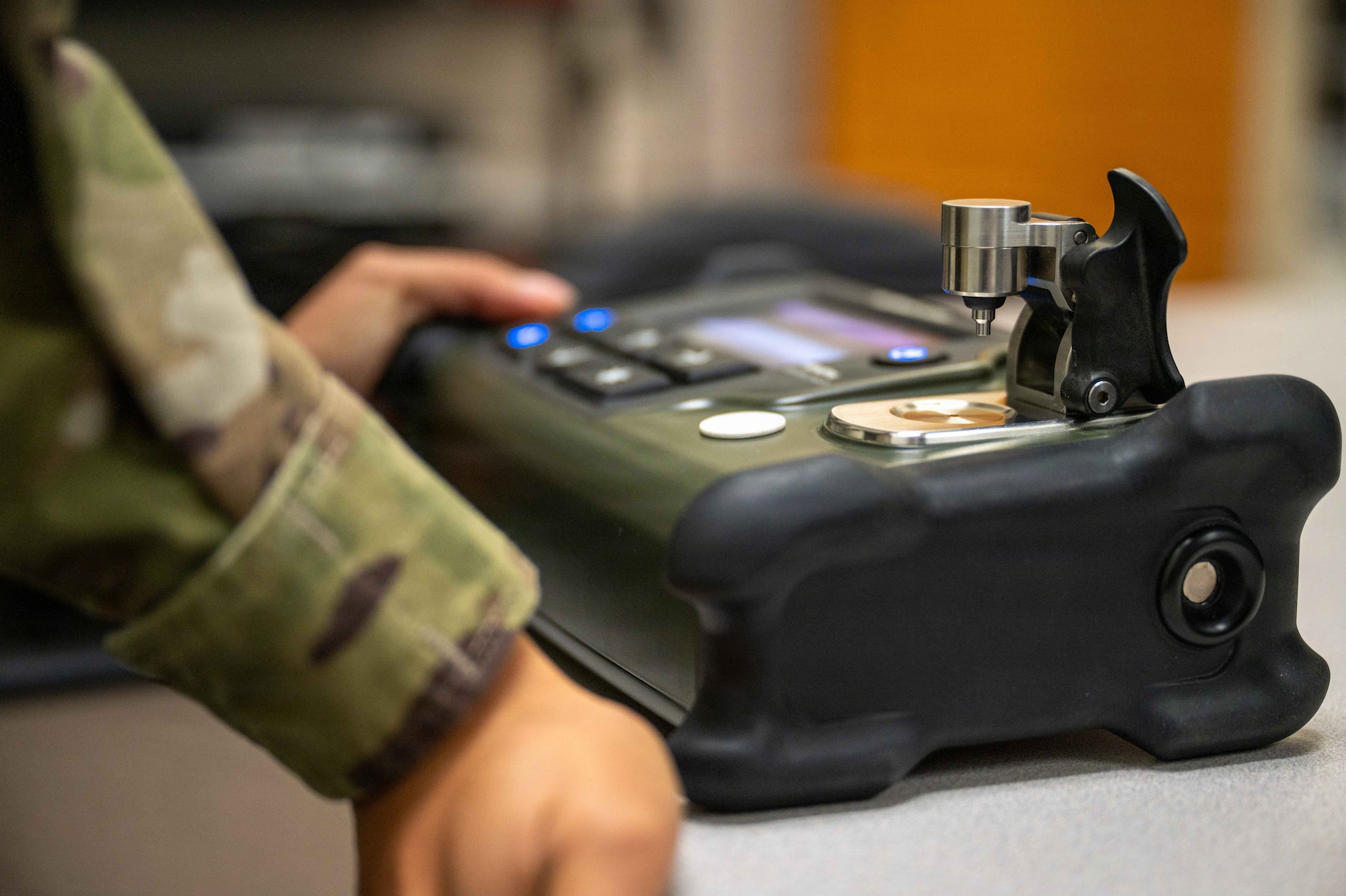 U.S. Air Force Airman 1st Class Arely Ramirez-Munoz, bioenvironmental engineering technician, Maxwell Medical Group, calibrates a handheld hazardous material identifier at Maxwell Air Force base, Alabama, Oct. 30, 2025. The identifier is used by the bioenvironmental engineering team to identify unknown solid and liquid chemicals in the field. (U.S. Air Force photo by Senior Airman Evan Porter)
