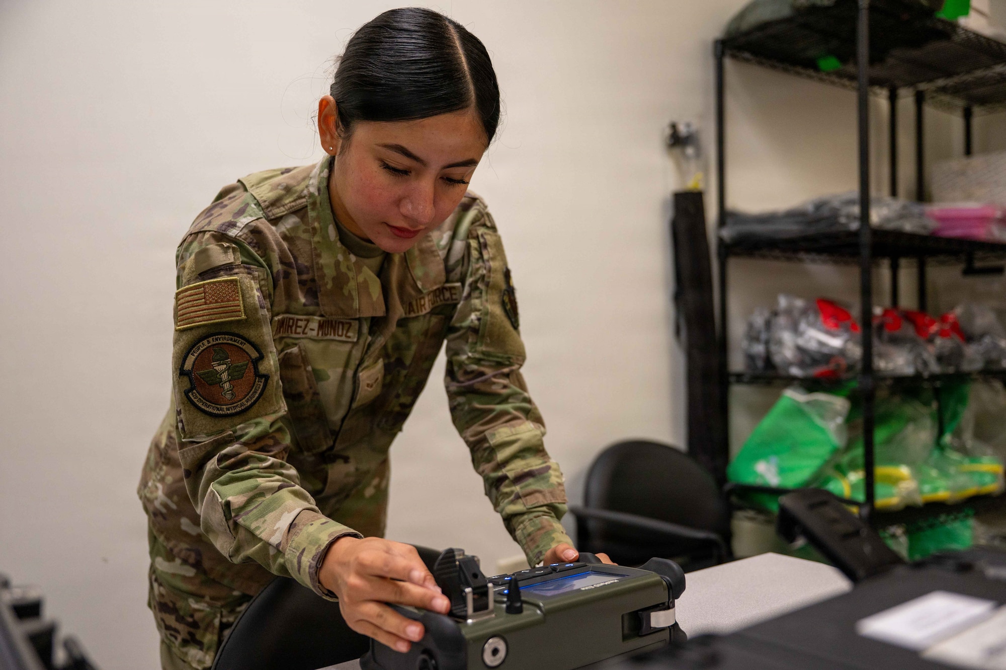 U.S. Air Force Airman 1st Class Arely Ramirez-Munoz, bioenvironmental engineering technician, Maxwell Medical Group, calibrates a handheld hazardous material identifier at Maxwell Air Force base, Alabama, Oct. 30, 2025. The identifier is used by the bioenvironmental engineering team to identify unknown solid and liquid chemicals in the field. (U.S. Air Force photo by Senior Airman Evan Porter)