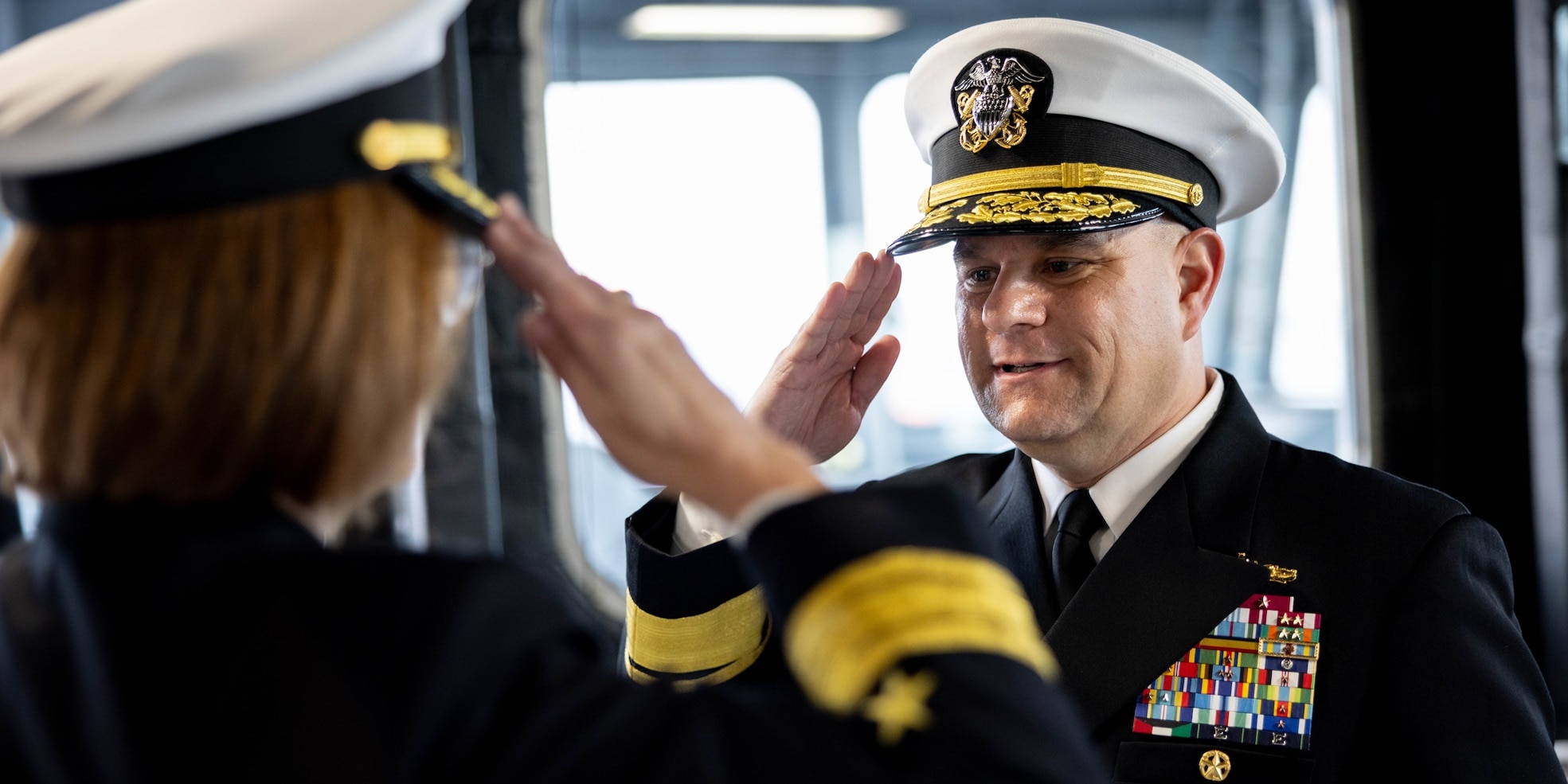 Rear Adm. Benjamin R. Nicholson, prospective Commander, Military Sealift Command (MSC), right, renders a salute to Rear Adm. Kimberly Walz, acting Commander, Military Sealift Command, and assumes the role of commanding officer during MSC’s assumption of command ceremony held on board USNS Robert F. Kennedy  (T-AO 208) Nov. 13, 2025. The ceremony is a time-honored tradition that marked the moment a new commander formally takes charge of a unit in the absence of an outgoing commander.