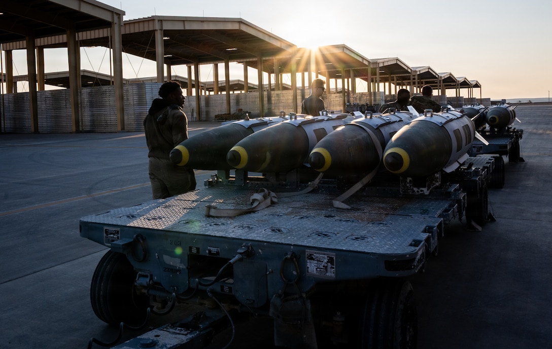 U.S. CENTRAL COMMAND AREA OF RESPONSIBILITY (Dec. 18, 2025) U.S. Airmen prepare to load GBU-31 munition systems onto F-15E Strike Eagles at a base in the U.S. Central Command area of responsibility, Dec. 18, 2025. (U.S. Air Force Photo)