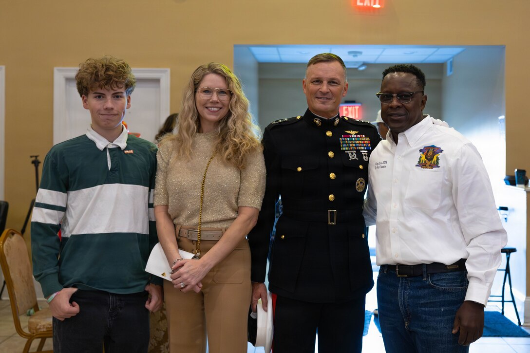 U.S. Marine Corps Lt. Gen. Leonard F. Anderson IV, commander of Marine Forces Reserve and Marine Forces South, poses for a picture with his family and Dr. Ron Tassin, the Zulu King of the Zulu Social Aid and Pleasure Club, during a Toys for Tots event in New Orleans, Dec. 20, 2025. The Zulu Social Aid and Pleasure Club, New Orleans’ largest predominantly African American Carnival organization, hosted a Toys for Tots event open to the local community of New Orleans, where attendees received gifts provided by the Marine Corps and fellow members of the community. (U.S. Marine Corps photo by Lance Cpl. Claire Cheney)