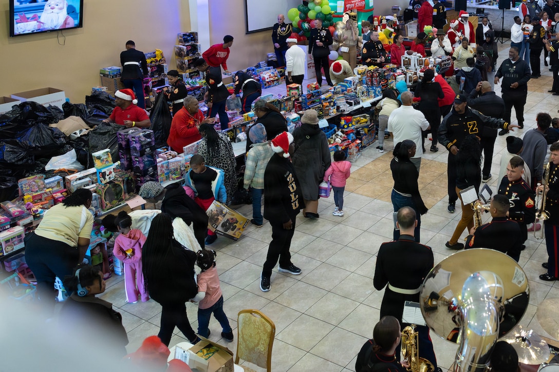 Members of the New Orleans community gather at the Zulu Social Aid and Pleasure Club in attendance of a Toys for Tots event in New Orleans, Dec. 20, 2025. The Zulu Social Aid and Pleasure Club, New Orleans’ largest predominantly African American Carnival organization, hosted a Toys for Tots event open to the local community of New Orleans, where attendees received gifts provided by the Marine Corps and fellow members of the community. (U.S. Marine Corps photo by Lance Cpl. Claire Cheney)