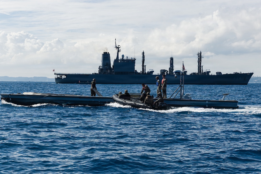 U.S. Marines with India Company, Battalion Landing Team 3rd Battalion, 1st Marine Regiment, 31st Marine Expeditionary Unit, conduct a simulated resupply with supplies from an autonomous low-profile vessel to during unmanned surface vessel training operations as part of MEU Exercise at White Beach Naval Facility, Okinawa, Japan on Dec. 2, 2025. The ALPV has the ability to deliver multiple variations of supplies and equipment through contested maritime terrain. The 31st MEU, the Marine Corps’ only continuously forward deployed MEU, provides a flexible and lethal force, ready to perform a wide range of military operations as the premiere crisis response force in the Indo-Pacific region. (U.S. Marine Corps photo by Sgt. Alora Finigan)
