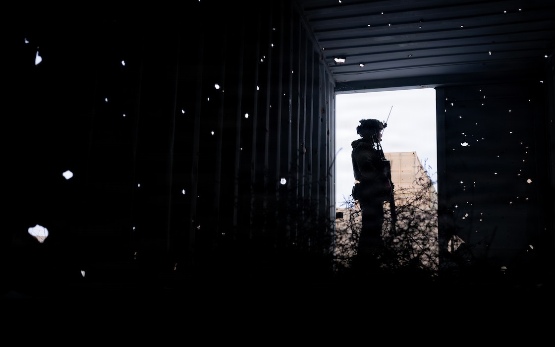 A silhouette of an Airman in tactical gear stands during a close air support training.