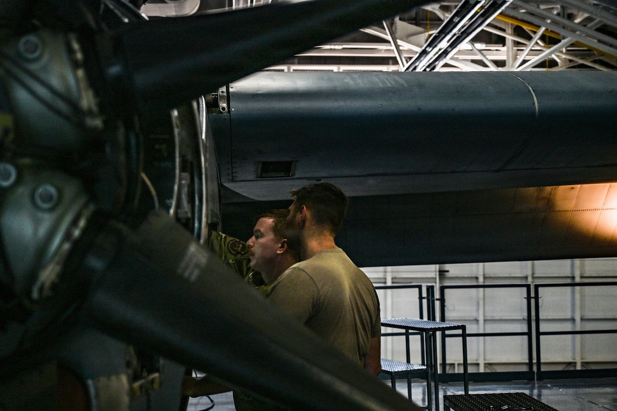 U.S. Master Sgt. Dan Doyle and Tech Sgt. Alex Morin, propulsion technicians with the 103d Maintenance Group, complete engine maintenance on a C-130 Hercules in the hangar in East Granby, Conn., on Oct. 3, 2025.