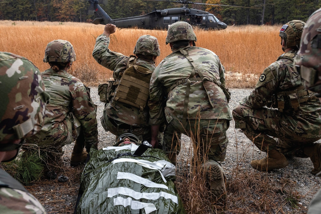 Army UH-60L Black Hawk helicopter crew chiefs with Charlie Company, Detachment 2, 1-171st General Support Aviation Battalion, 57th Troop Command, New Jersey Army National Guard, conduct medical evacuation training with combat medics with 1st Battalion, 114th Infantry Regiment, 44th Infantry Brigade Combat Team, New Jersey Army National Guard, at Joint Base McGuire-Dix-Lakehurst, New Jersey, November 7, 2023
