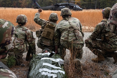Army UH-60L Black Hawk helicopter crew chiefs with Charlie Company, Detachment 2, 1-171st General Support Aviation Battalion, 57th Troop Command, New Jersey Army National Guard, conduct medical evacuation training with combat medics with 1st Battalion, 114th Infantry Regiment, 44th Infantry Brigade Combat Team, New Jersey Army National Guard, at Joint Base McGuire-Dix-Lakehurst, New Jersey, November 7, 2023