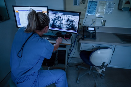 U.S. Air Force Capt. Taylor Smith, general dentist, Maxwell Medical Group, reviews a patient’s dental x-ray at Maxwell Air Force Base, Alabama, Oct. 9, 2025. Air Force members are required to have yearly dental checks to maintain their readiness to deploy. (U.S. Air Force photo by Senior Airman Evan Porter)