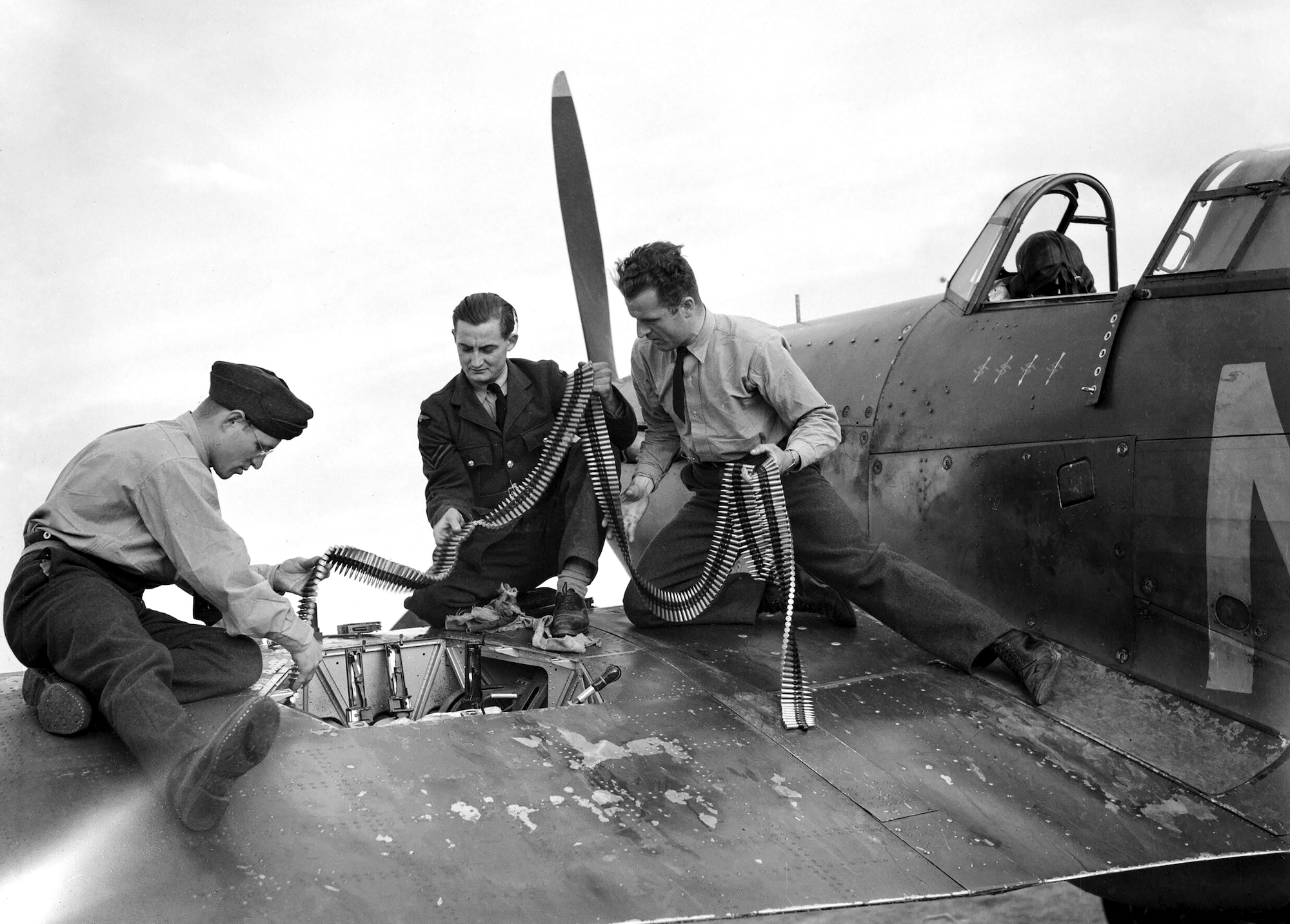 Armorers replenish a Hurricane’s ammunition, September 1940. The Hurricane’s speed and formidable armament made it a deadly opponent of the Luftwaffe.